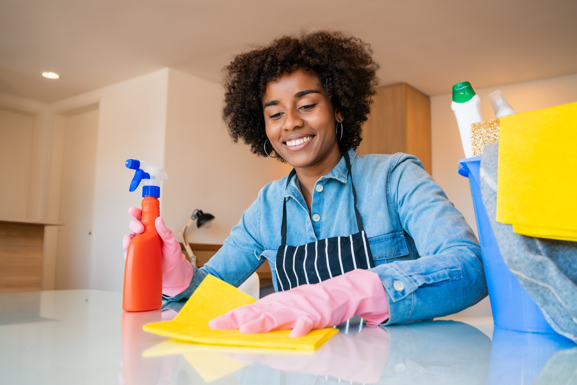 afro woman cleaning home